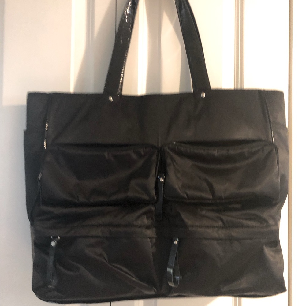 FURLA black shoulder bag with 4 front zipper pockets and side pockets .